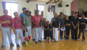 Coach Pickens & members of his CBAT team, Mustafa Khan & Mama Delores Sheen with kids from Sheenaway, at the HOF Plaque presentation.Photo by David Sentance